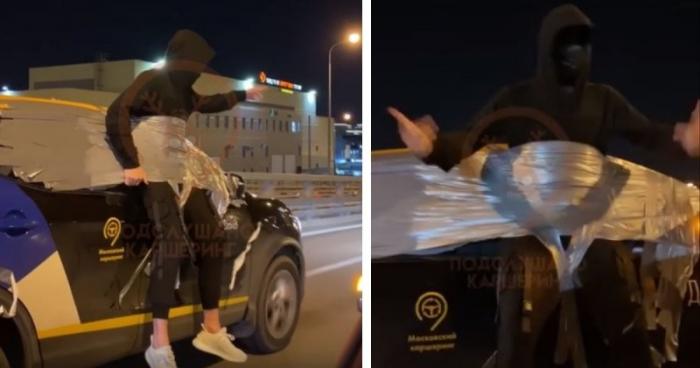 Приклеенный скотчем к машине мужик в маске (3 фото)